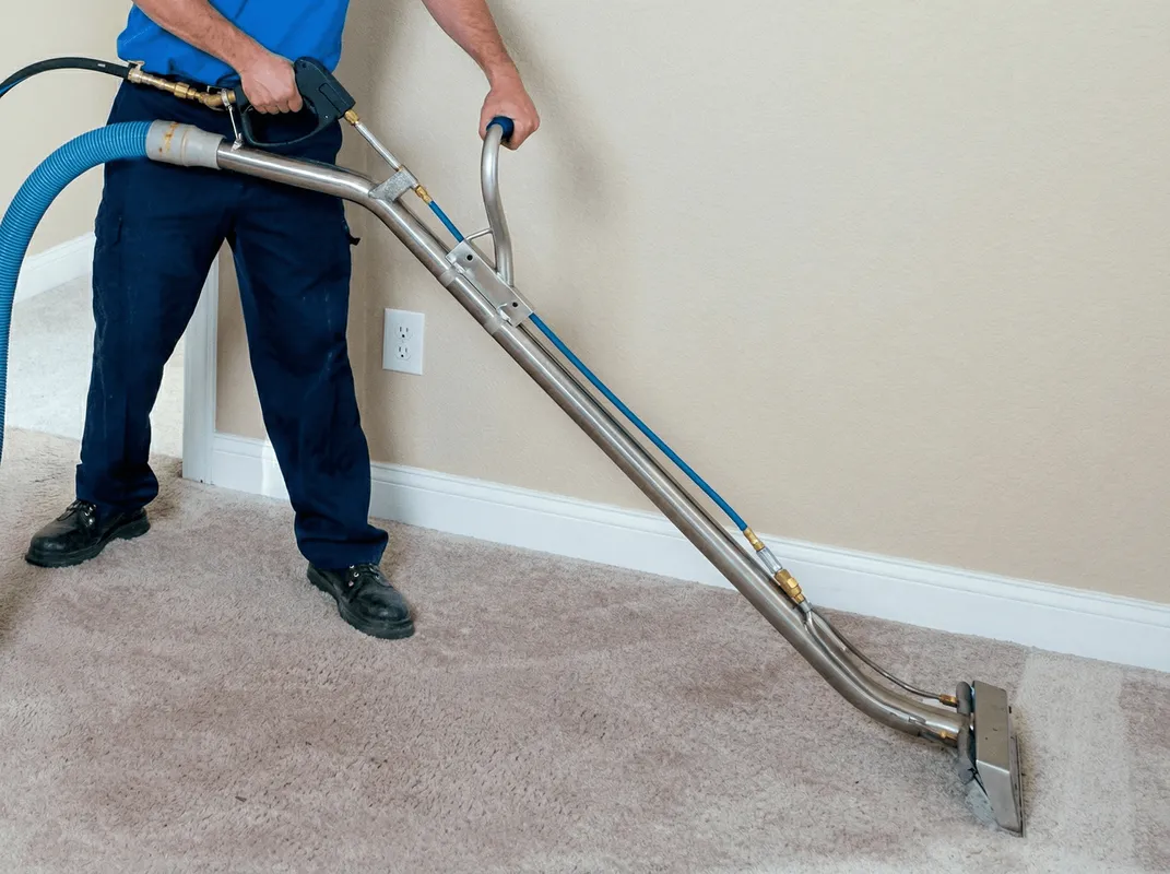 Professional operating a liquid removal machine on a carpeted floor in Dayton, OH